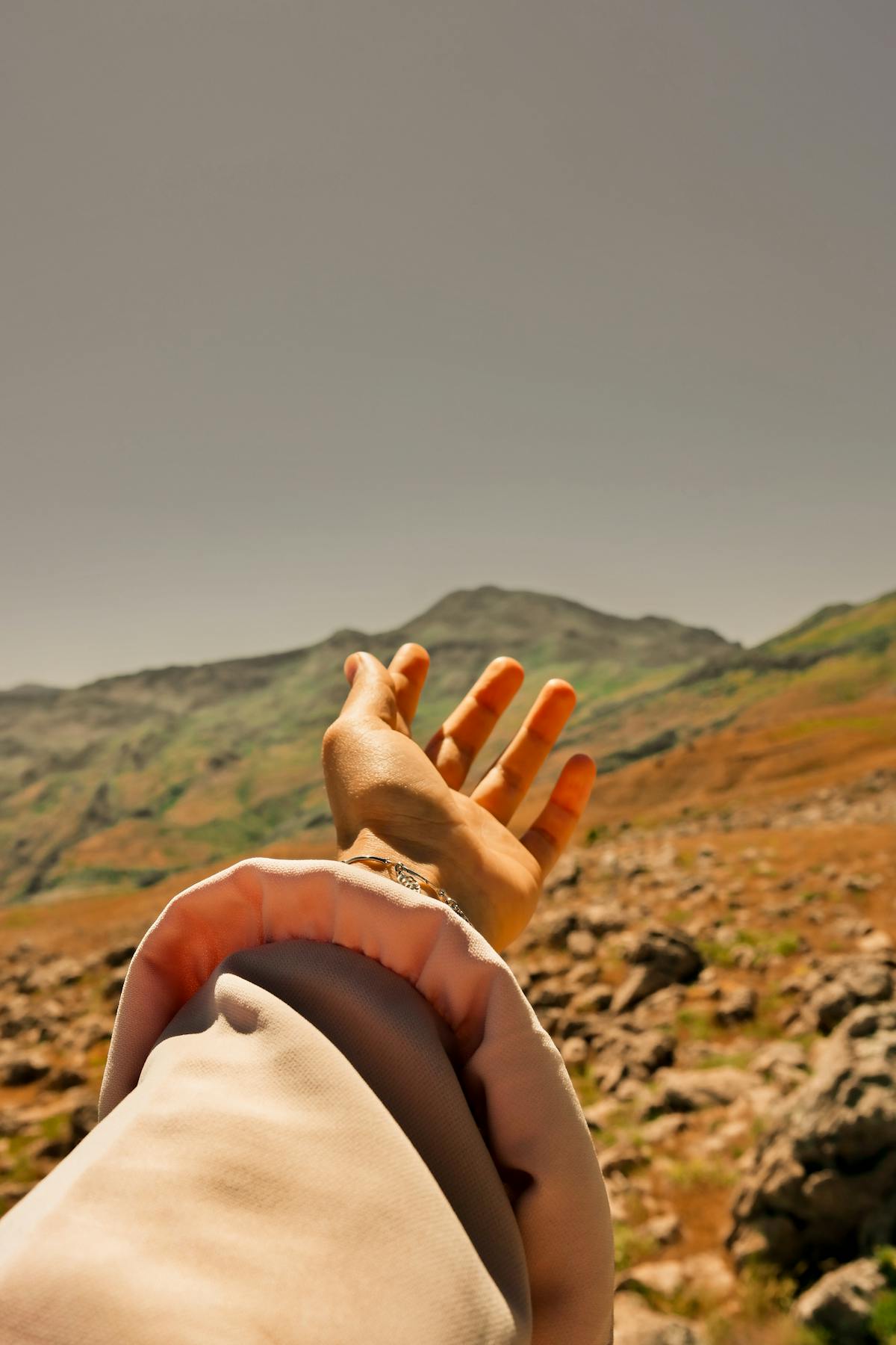 A hand stretched towards the ridge, thin bracelets — Mălăiești 2024